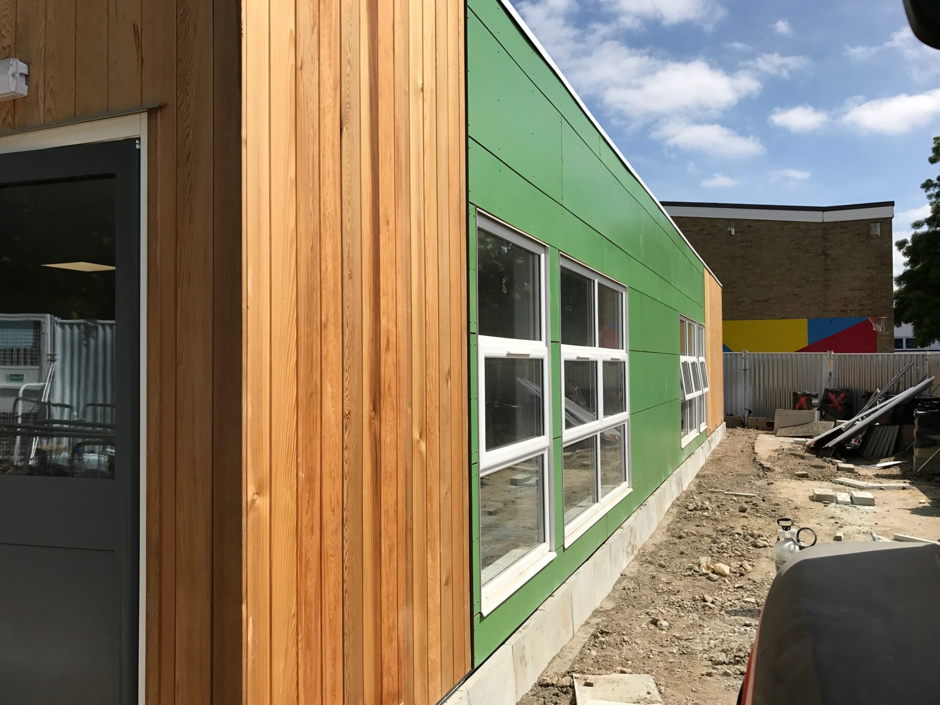 Vertical cedar cladding with green Rockpanel - screw: nail fixed to timber battens img