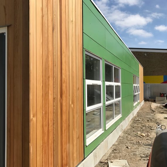 Vertical cedar cladding with green Rockpanel - screw: nail fixed to timber battens img